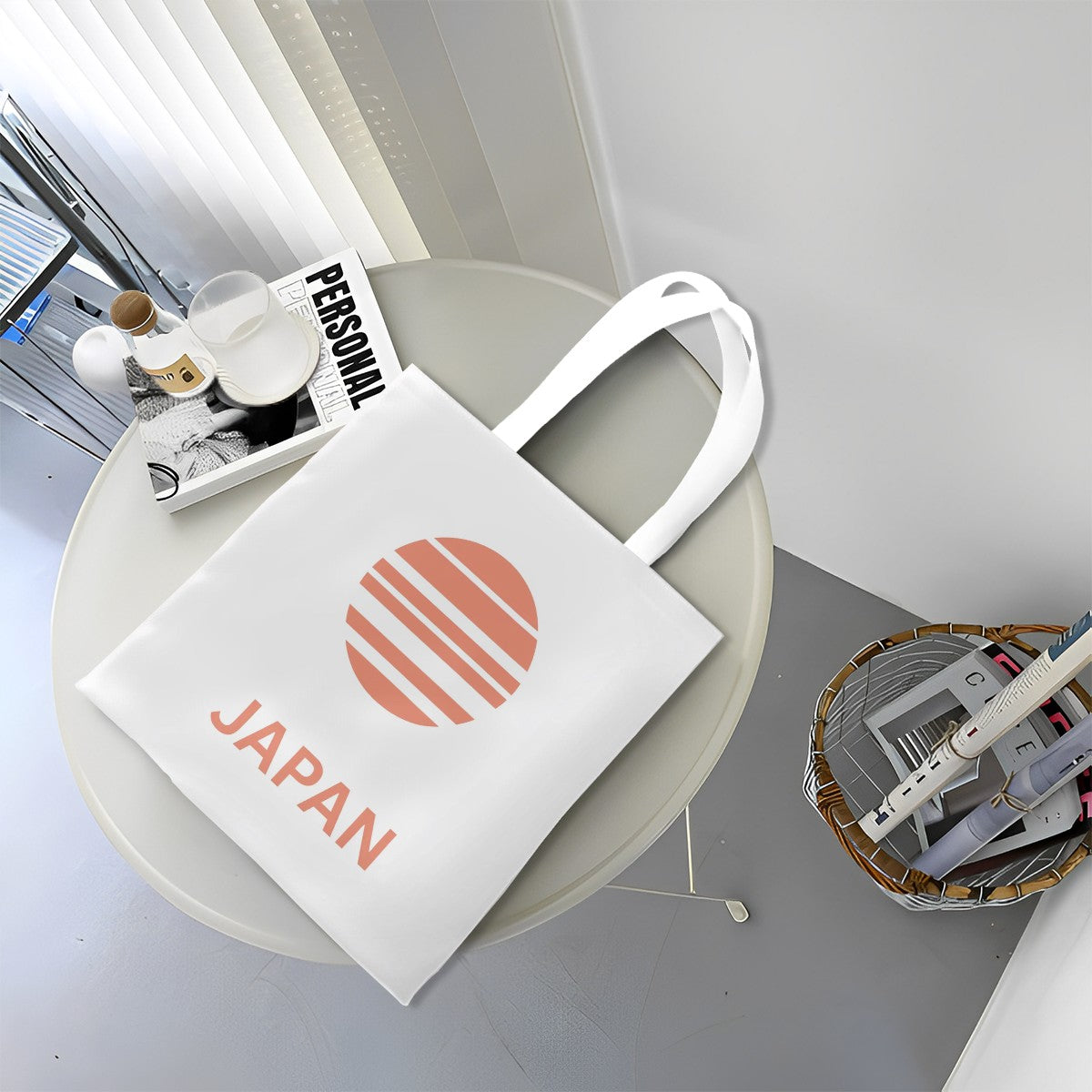 White tote bag with 'Japan' and sun design on a round white table.