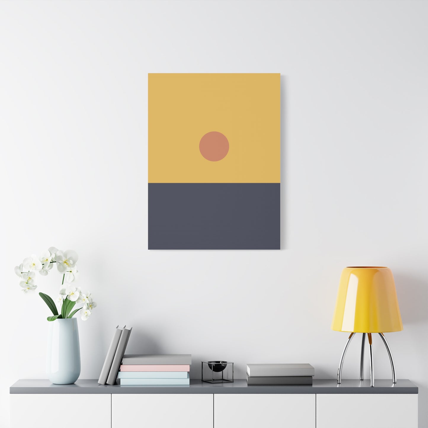 Abstract art piece with a yellow and gray color scheme on a white wall above a shelf.