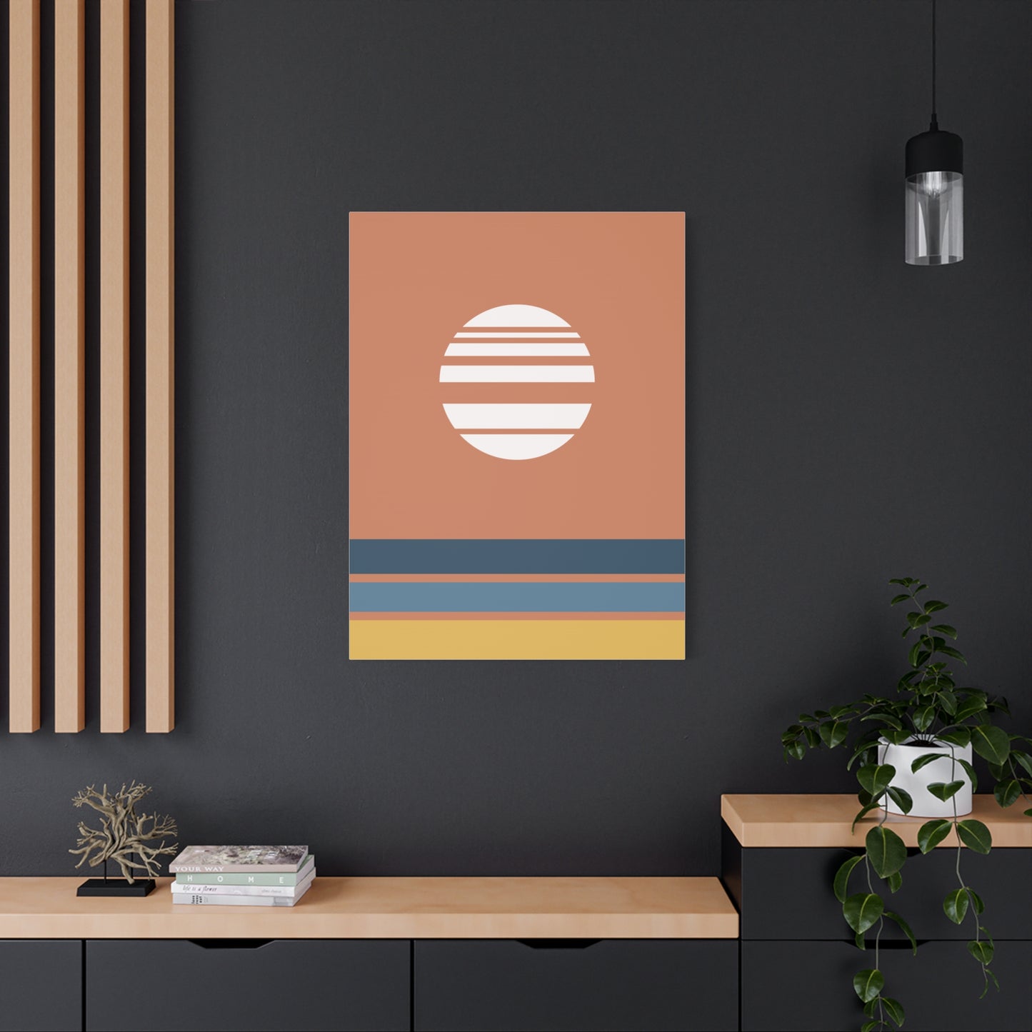 Abstract wall art with a sun design on a dark wall, with a modern interior setting.