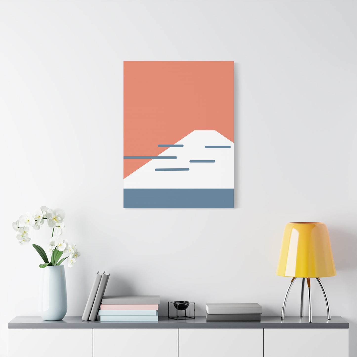 Abstract wall art with geometric design on a white wall above a shelf.