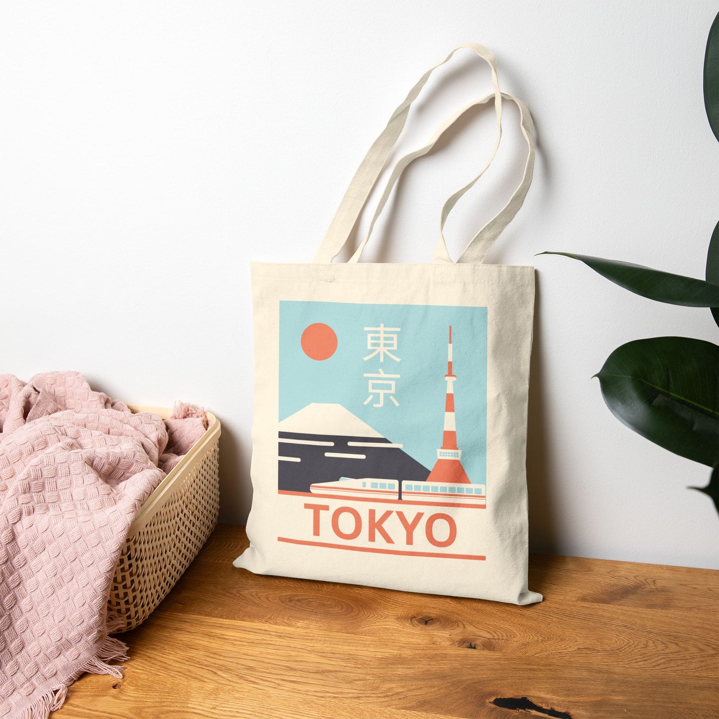 Tote bag with Tokyo design on a wooden surface with a plant in the background