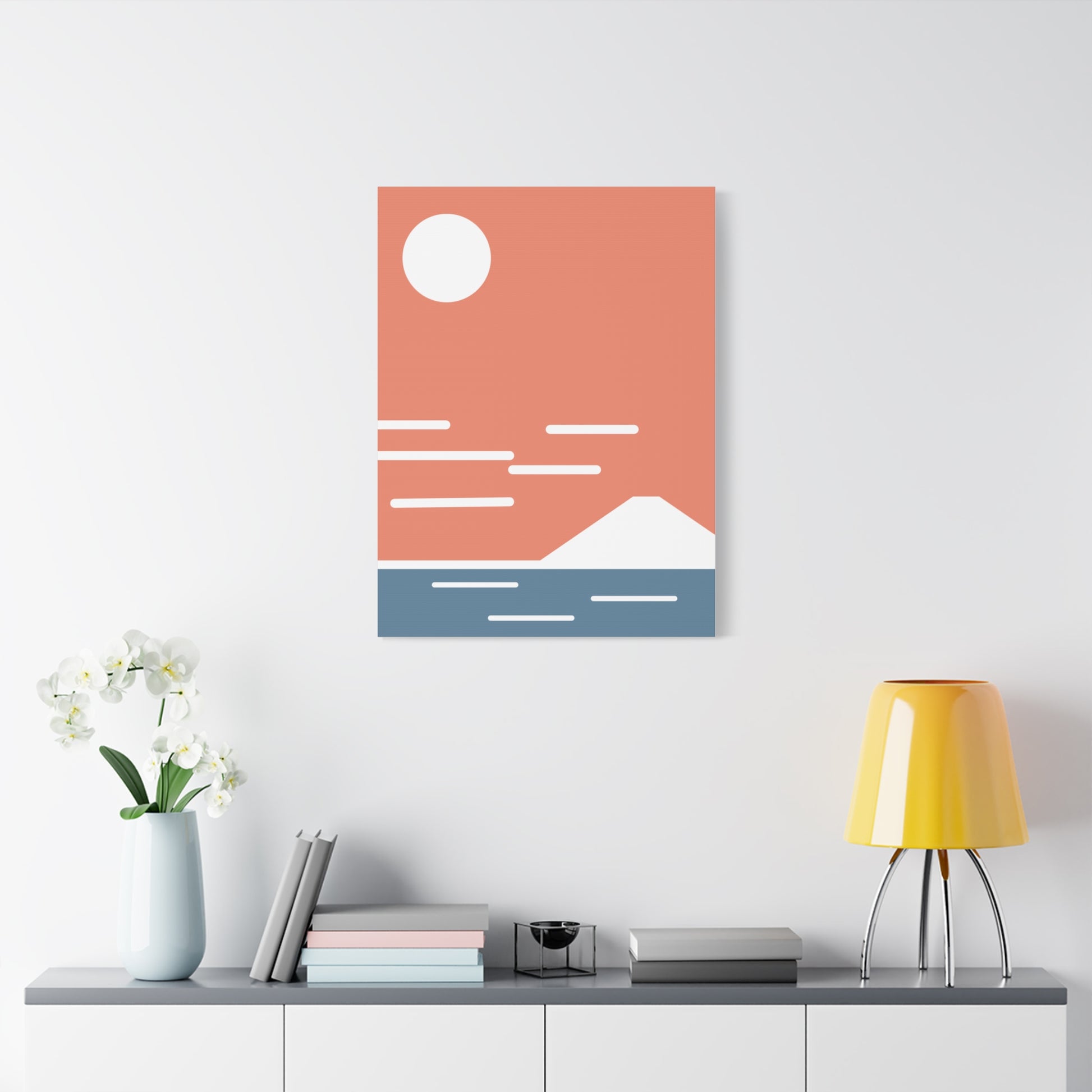 Abstract wall art with geometric design on a white wall above a shelf.