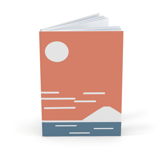 Notebook with a minimalist design of a mountain, lake, and sun on a white background