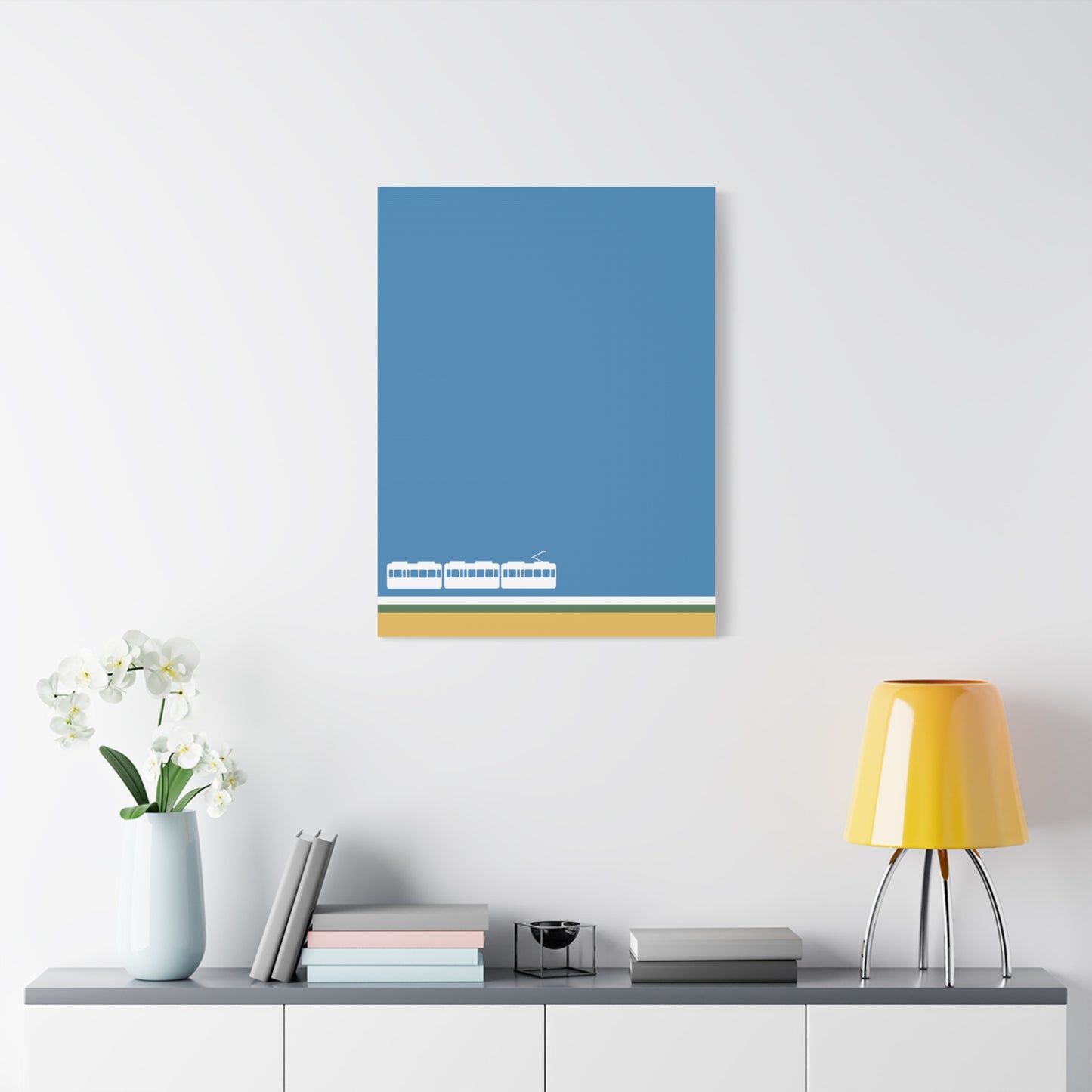 Blue abstract painting on a white wall above a shelf with decor items.
