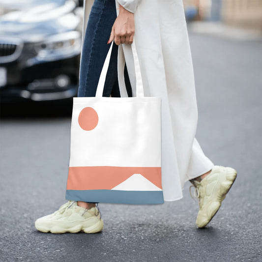 Person holding a tote bag with geometric design on a street