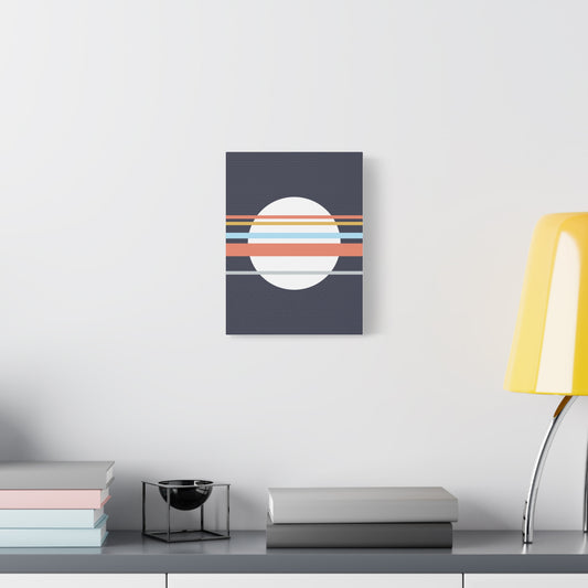 Abstract wall art with concentric circles on a dark blue background, displayed on a white wall above a desk.