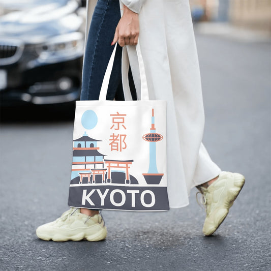 Person holding a tote bag with Kyoto design and text