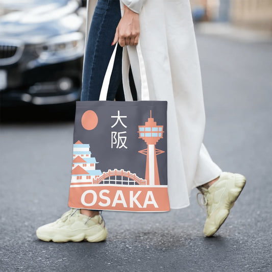 Person holding a tote bag with Osaka design on a street