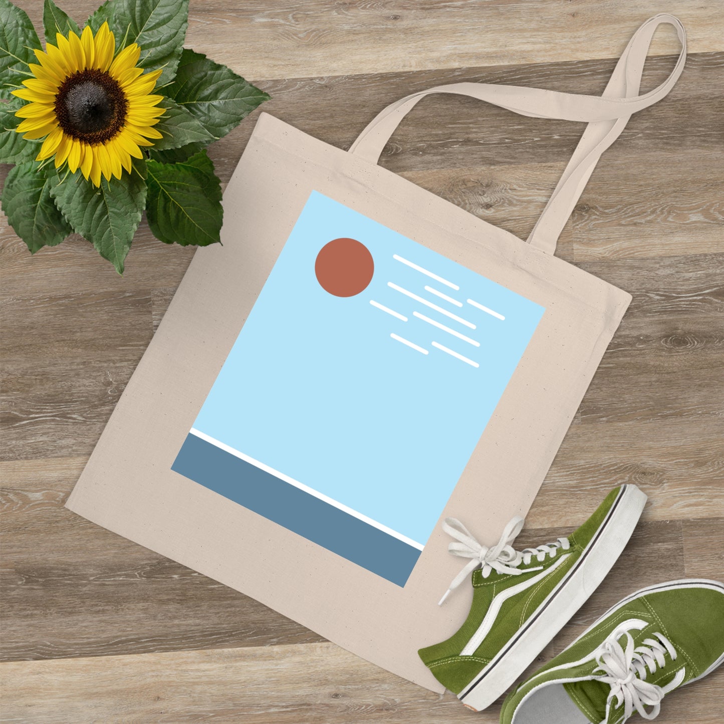 Tote bag with a design, green sneakers, and a sunflower on a wooden surface
