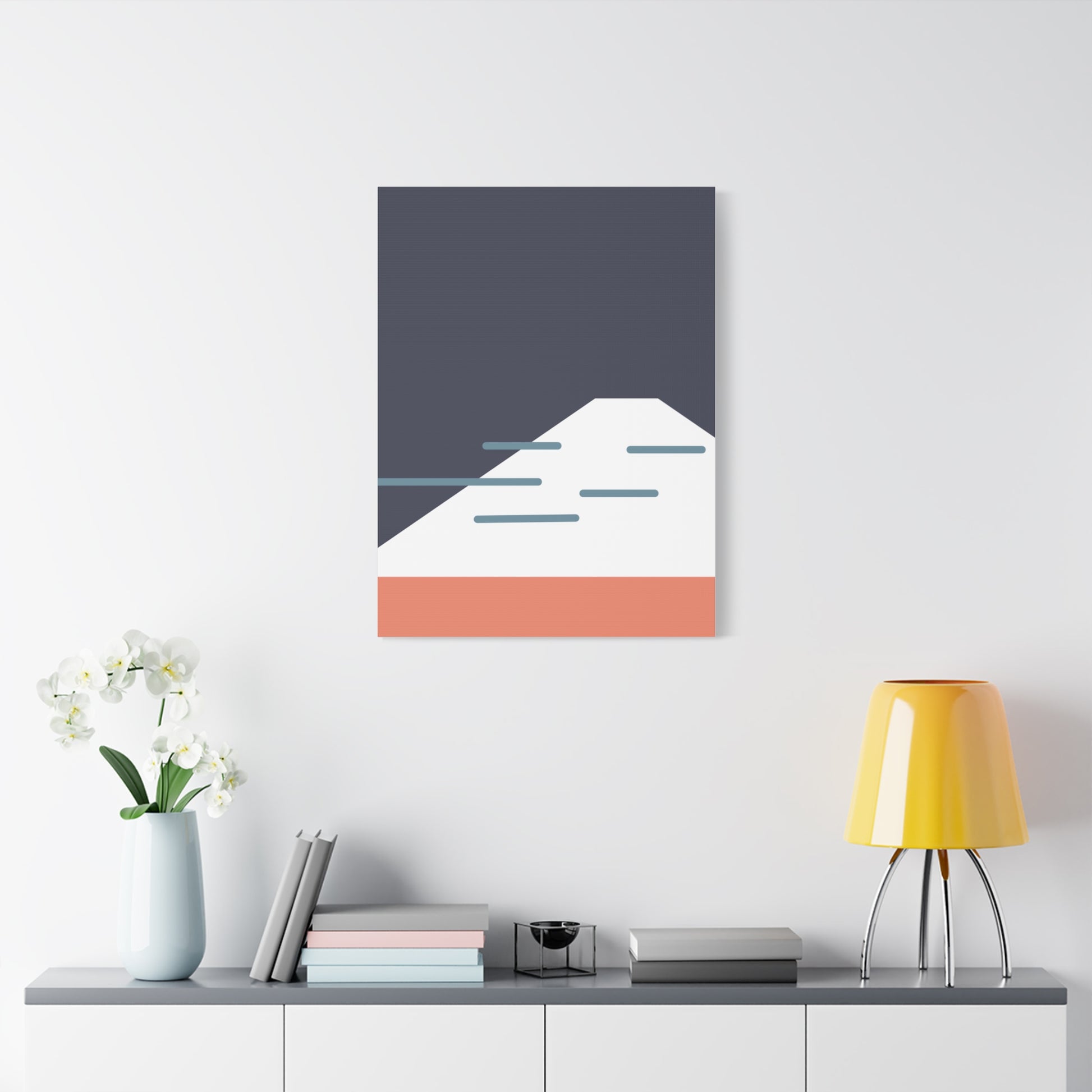 Abstract wall art with geometric design on a white wall above a shelf.