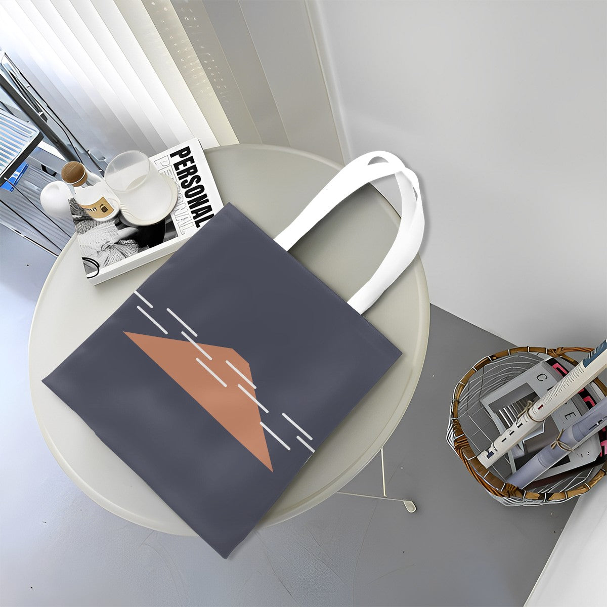 Gray tote bag with a brown triangle design on a round table.