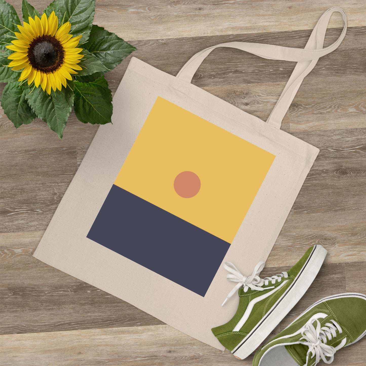 Beige tote bag with geometric design, green sneakers, and sunflower on wooden surface