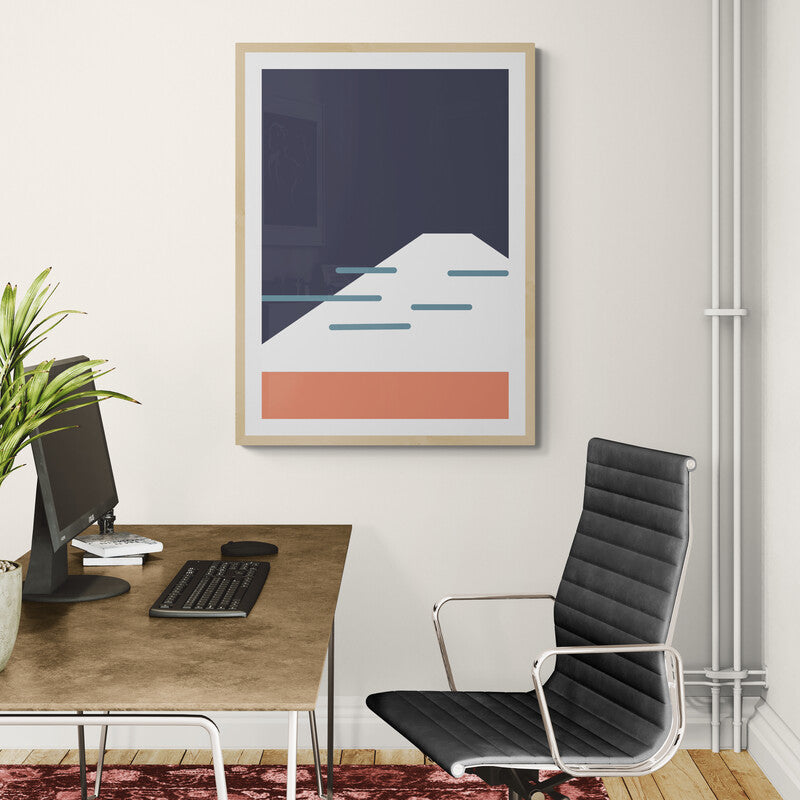 Modern office setup with a desk, chair, and framed abstract art on the wall.