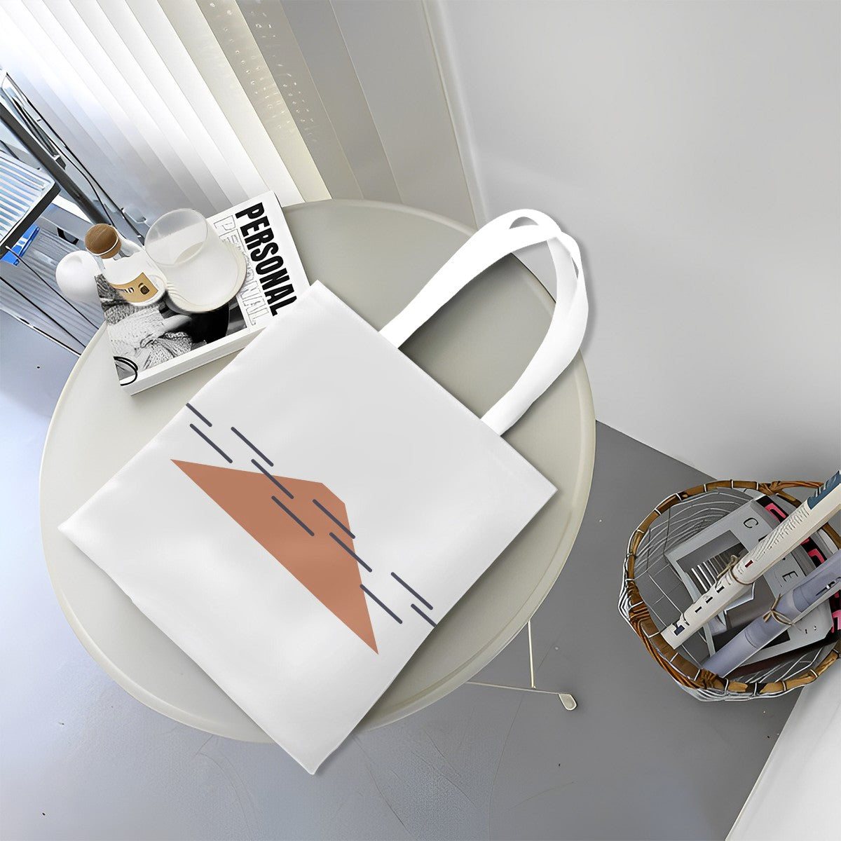 White tote bag with a geometric design on a round white table.