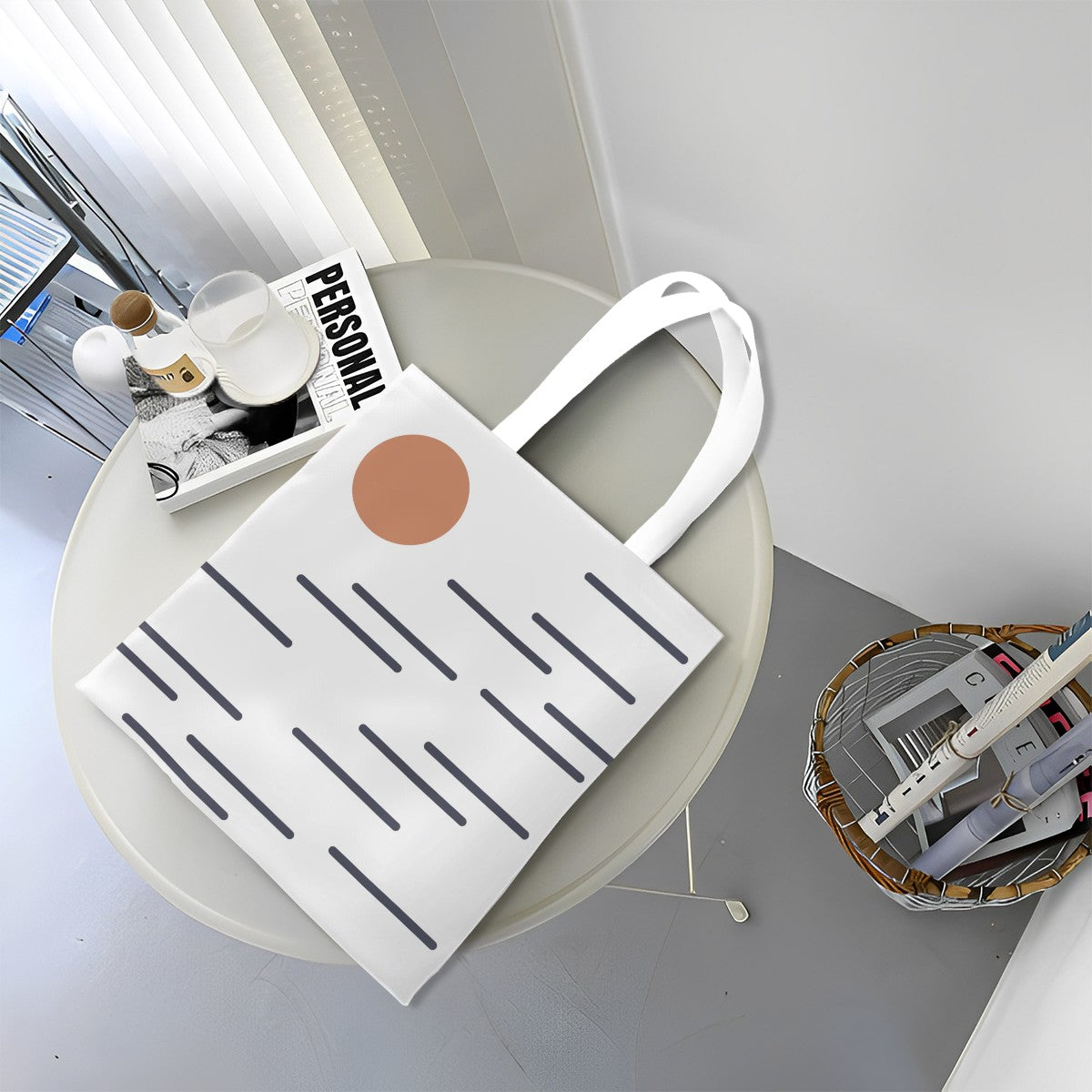 White tote bag with a brown circle and black lines on a round white table.