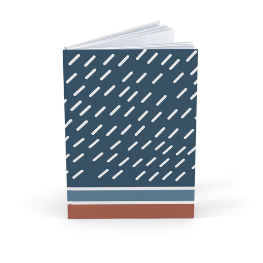 Notebook with a blue cover featuring white diagonal stripes and a brown bottom section on a white background