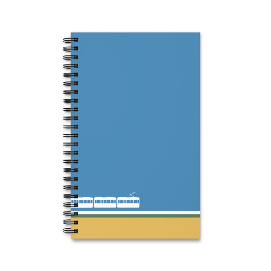 Notebook with blue cover and yellow bottom section on a white background