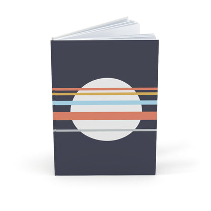 Notebook with a circular design featuring horizontal stripes on a dark blue background