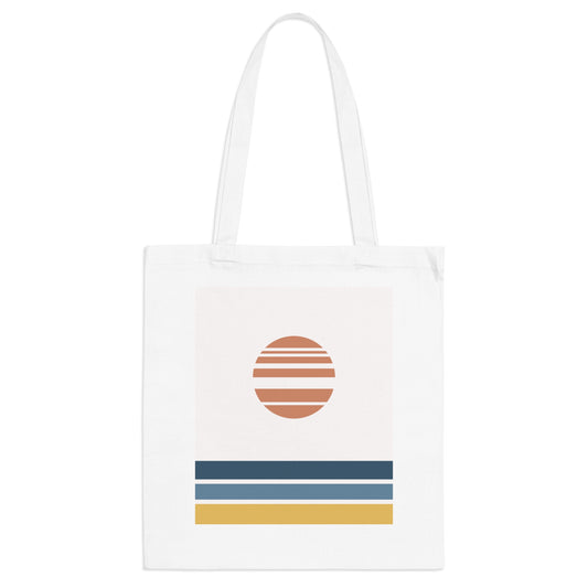White tote bag with a colorful design featuring a sun and horizontal stripes on a white background
