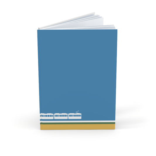 Notebook with a blue cover featuring a tram design on a white background