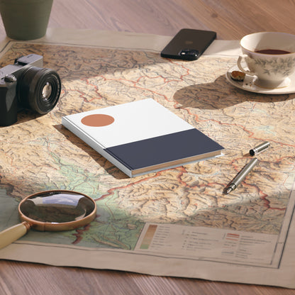 Notebook, camera, magnifying glass, and tea cup on a map