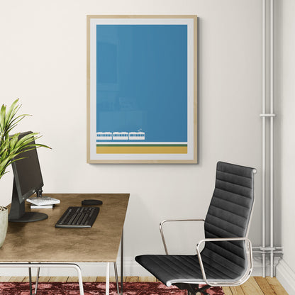 Modern office setup with a desk, chair, and framed artwork on a wall.