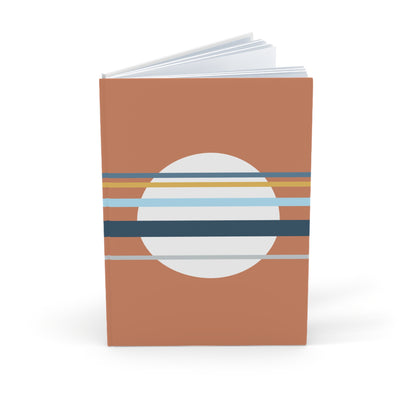 Notebook with a brown cover featuring a circular design with horizontal stripes on a white background