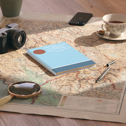 Notebook, camera, magnifying glass, and tea cup on a map