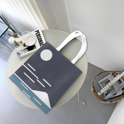 Blue tote bag with white handle on a round table in a home setting