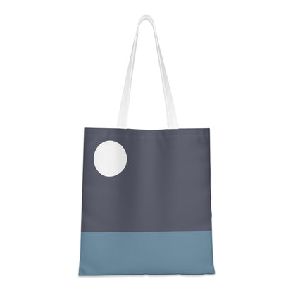 Tote bag with a white circle design on a two-tone blue background