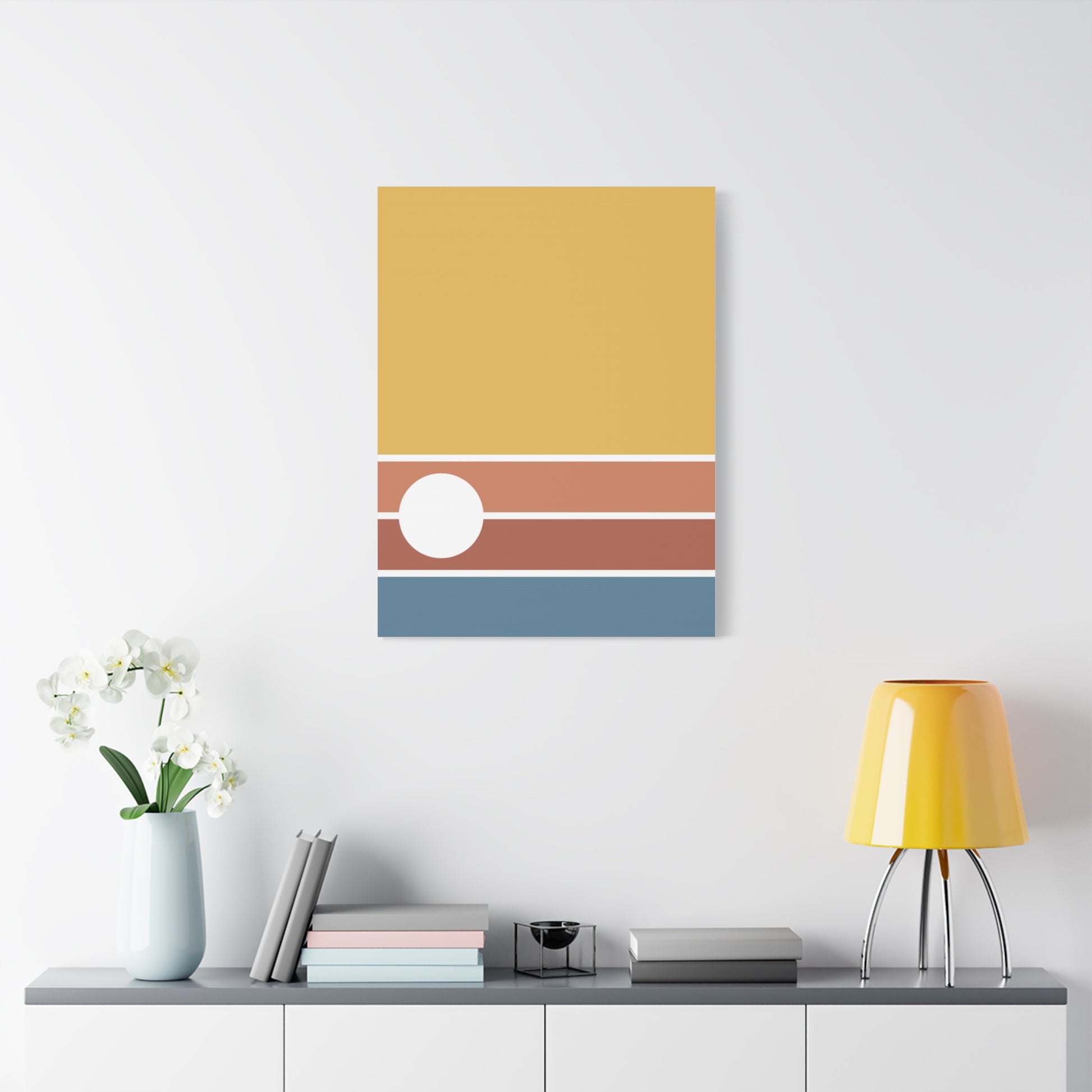 Colorful abstract wall art on a white wall with a shelf below.