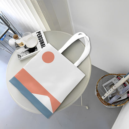 White tote bag with geometric design on a round white table