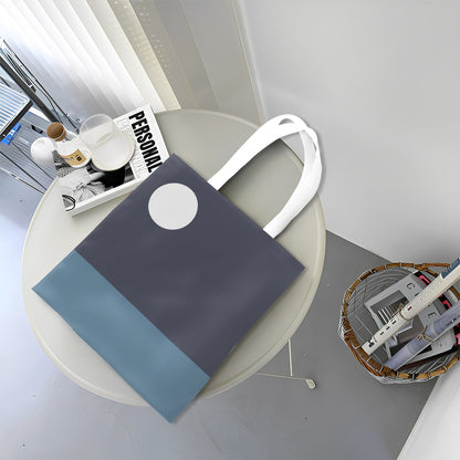 Blue tote bag with white handle on a round table